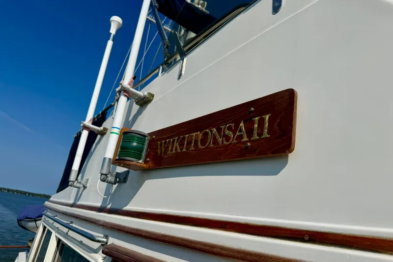 Slide: The Image of 1990 Grand Banks 36 Classic yacht cruising on a serene lake with forested shoreline. - 18