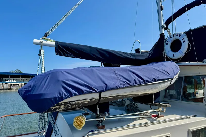 Slide: The Image of 1990 Grand Banks 36 Classic yacht cruising on calm waters, rear view. - 27