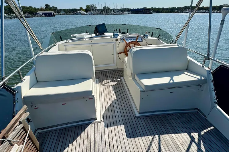 Slide: The Image of 1990 Grand Banks 36 Classic yacht on serene blue waters with distant shoreline. - 31