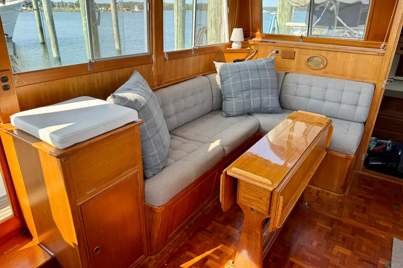 Slide: The Image of Helm of 1990 Grand Banks 36 Classic boat with wooden steering wheel and navigation equipment. - 37