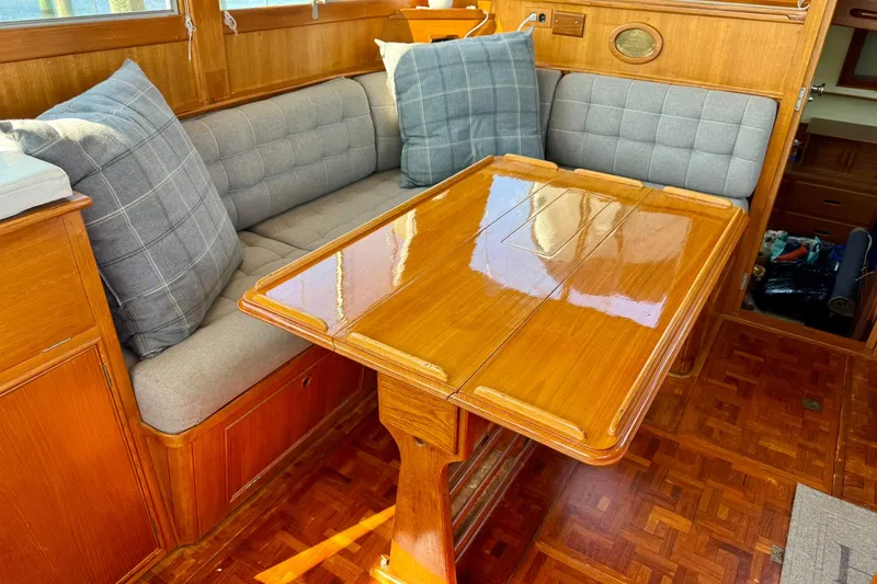 Slide: The Image of 1990 Grand Banks 36 Classic yacht deck with seating, overlooking calm waters. - 38