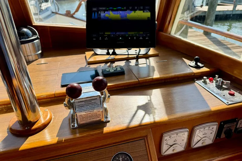 Slide: The Image of Side view of 1990 Grand Banks 36 Classic yacht on calm water. - 41