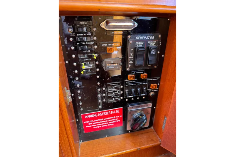 Slide: The Image of Engine room of a 1990 Grand Banks 36 Classic with red machinery and wooden flooring. - 43