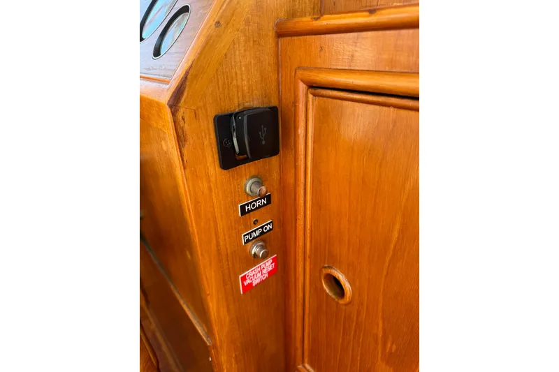 Slide: The Image of Engine room of 1990 Grand Banks 36 Classic with red machinery and control panel. - 44