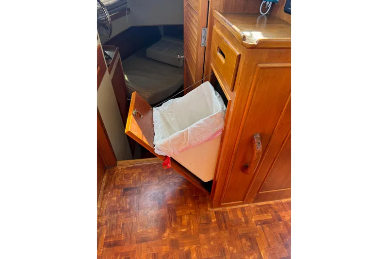 Slide: The Image of Engine room of a 1990 Grand Banks 36 Classic, showcasing a red marine engine. - 45