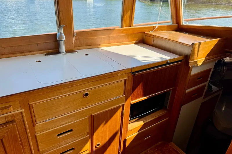 Slide: The Image of Engine room of 1990 Grand Banks 36 Classic with red engine components and wiring. - 46