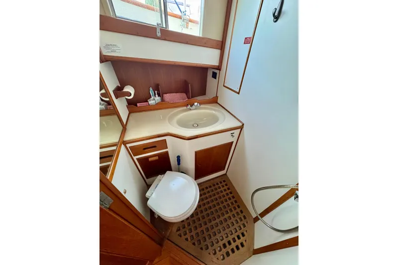 Slide: The Image of Marina with 1990 Grand Banks 36 Classic yacht docked, surrounded by boats and fuel station. - 54