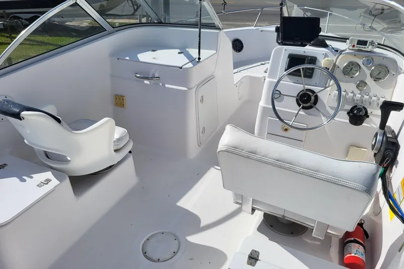 Slide: The Image of 2004 Pro-Line 20 DC boat interior with steering wheel, gauges, and seating. - 10