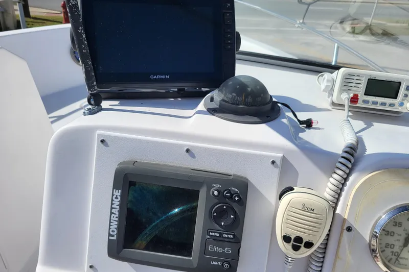 Slide: The Image of 2004 Pro-Line 20 DC boat dashboard with Garmin and Lowrance navigation systems. - 12
