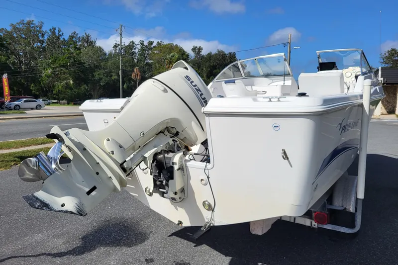 Slide: The Image of 2004 Pro-Line 20 DC boat with Suzuki outboard motor on a trailer. - 4