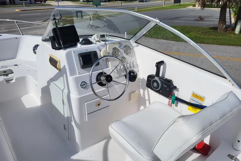 Slide: The Image of 2004 Pro-Line 20 DC boat cockpit with steering wheel, gauges, and controls. - 7