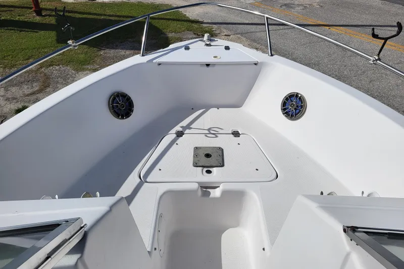 Slide: The Image of 2004 Pro-Line 20 DC boat interior, featuring spacious bow area with speakers and storage. - 8