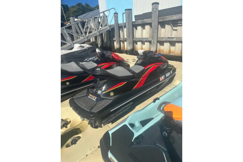 Slide: The Image of 2023 Kawasaki Jetski STX 160 parked on a dock under clear skies. - 3