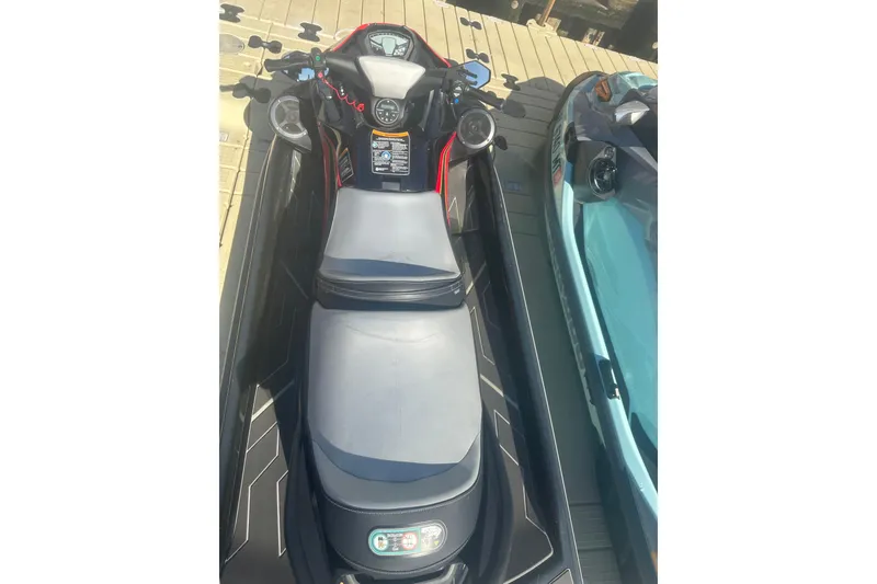 Slide: The Image of 2023 Kawasaki Jetski STX 160 on dock, top view, showcasing seat and controls. - 4
