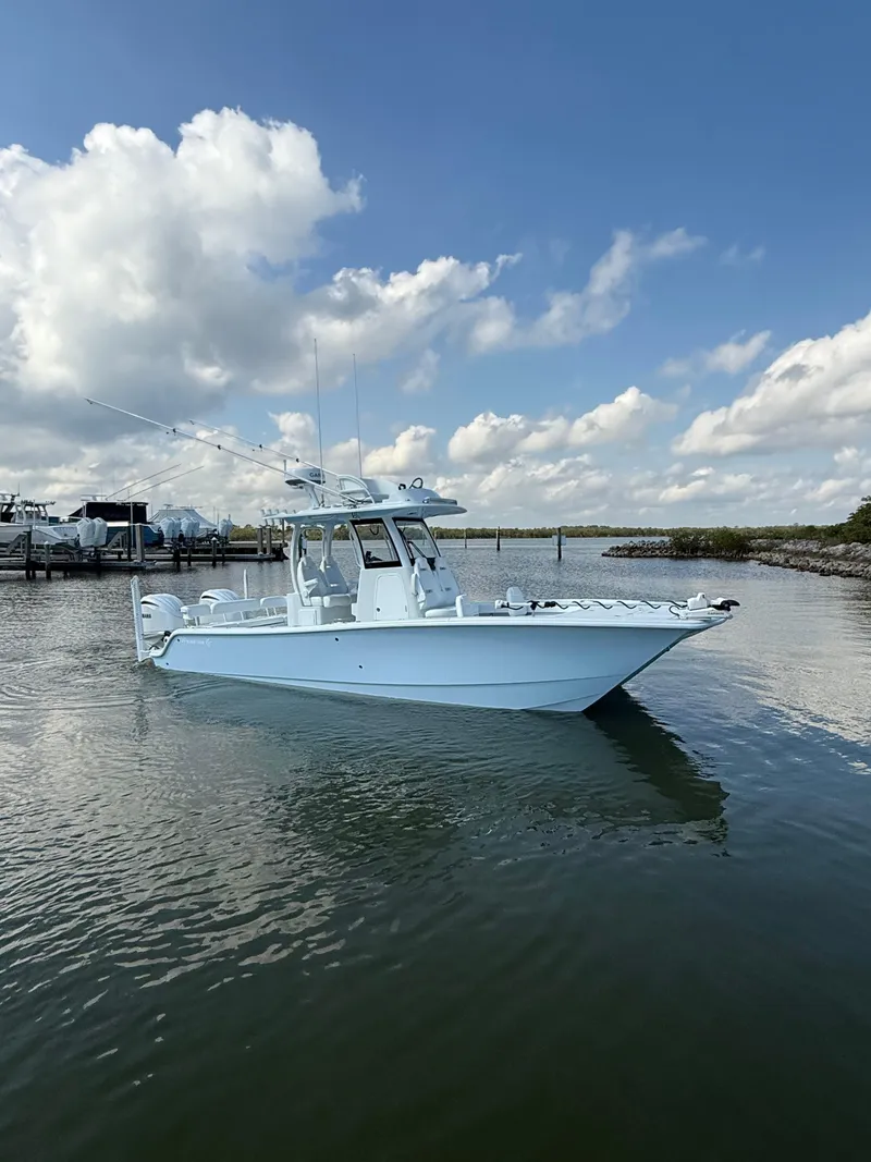 Slide: The Image of 2025 Freeman 28 boat on calm water under a partly cloudy sky. - 11