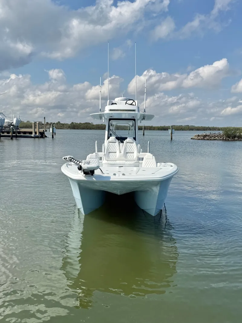 Slide: The Image of 2025 Freeman 28 boat on calm water under a partly cloudy sky. - 12