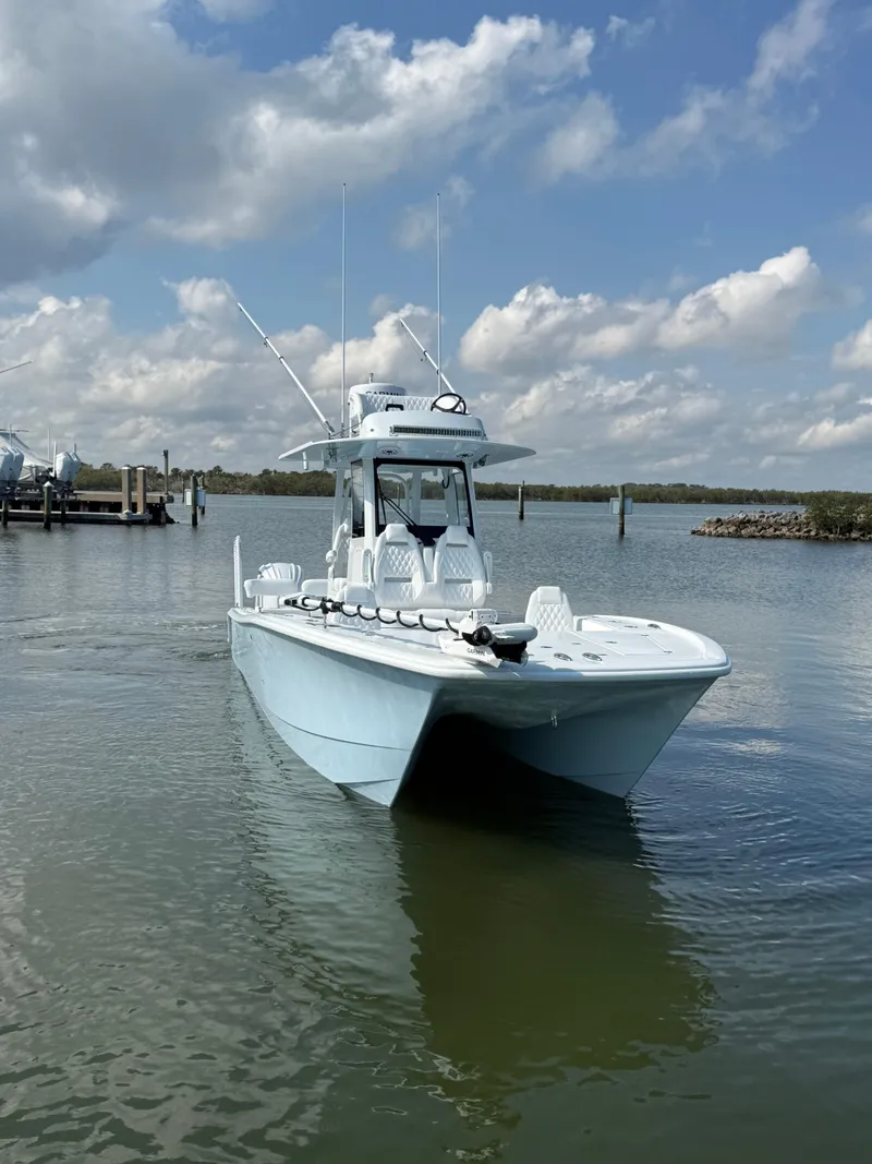 Slide: The Image of 2025 Freeman 28 boat on calm water under a partly cloudy sky. - 13