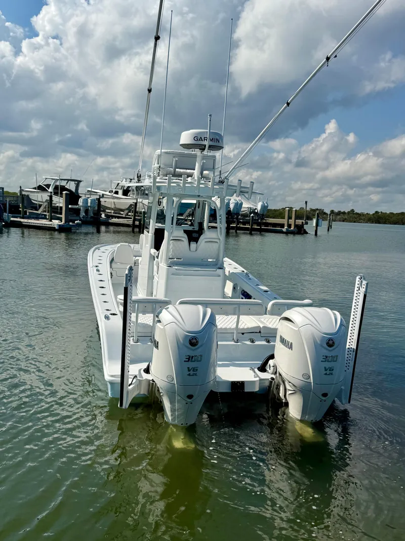 Slide: The Image of 2025 Freeman 28 boat with dual Yamaha engines docked in a marina. - 14