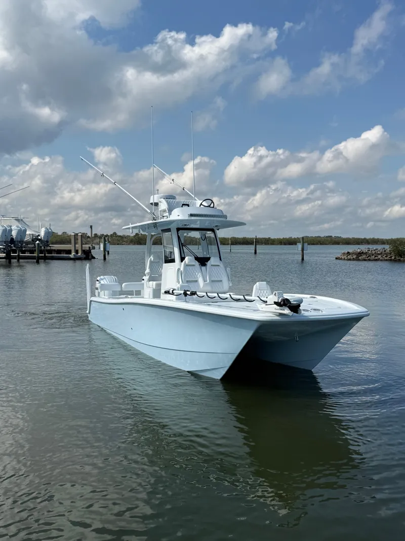 Slide: The Image of 2025 Freeman 28 boat on calm water under a partly cloudy sky. - 17