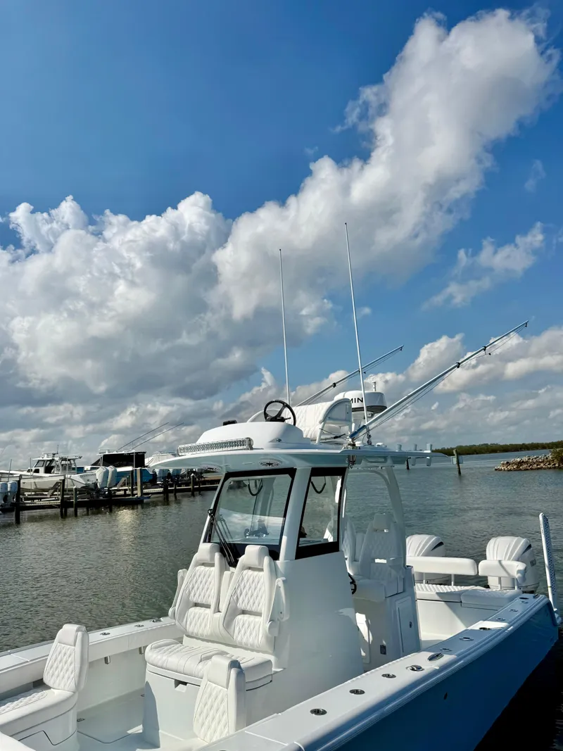 Slide: The Image of 2025 Freeman 28 boat docked under a partly cloudy sky. - 18