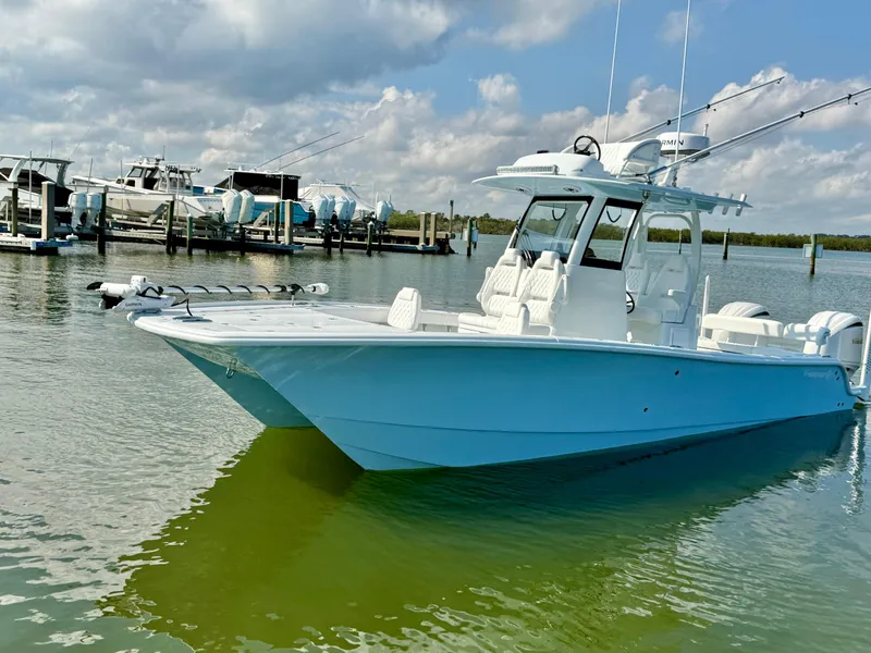 Slide: The Image of 2025 Freeman 28 boat docked in a marina under a partly cloudy sky. - 2