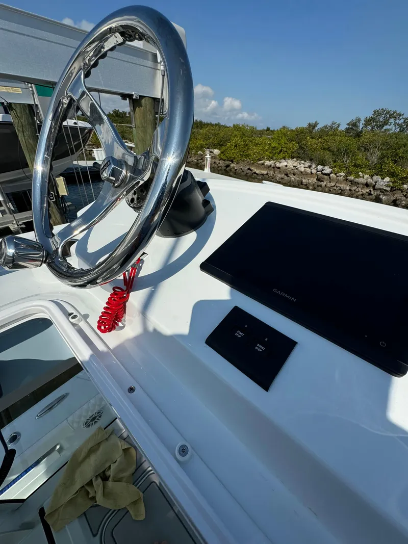 Slide: The Image of Freeman 28 boat dashboard with steering wheel and electronic display, 2025 model. - 22