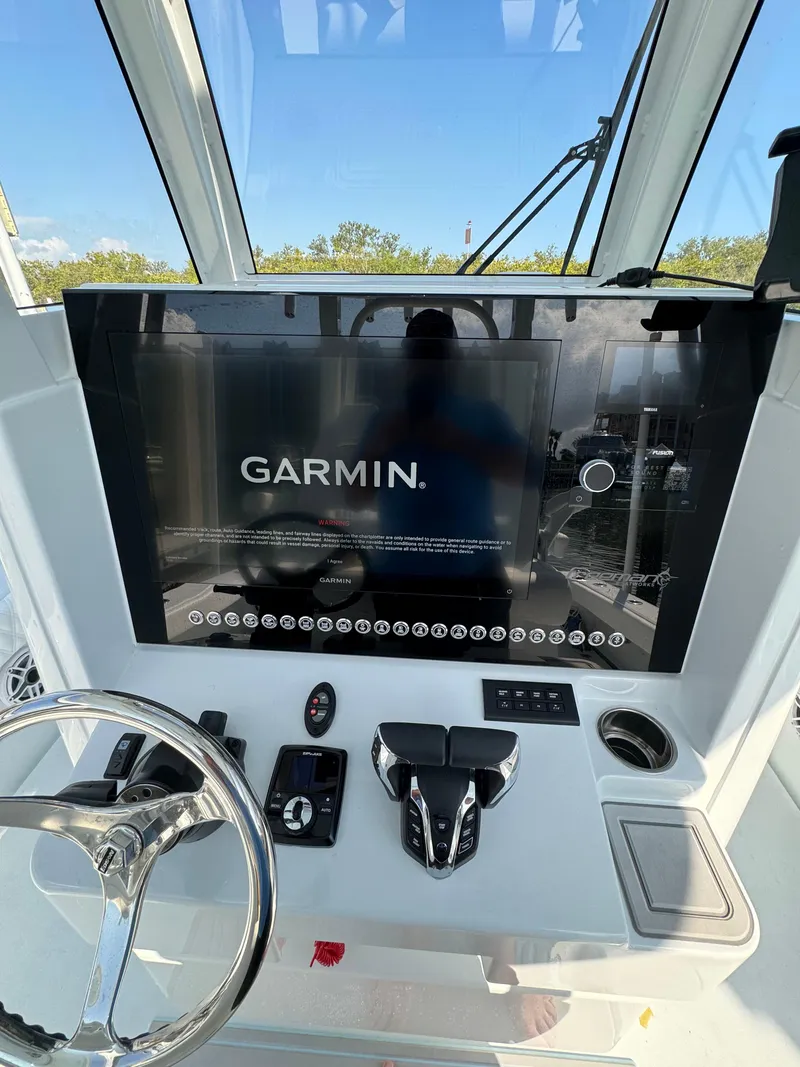 Slide: The Image of Freeman 28 boat dashboard with Garmin display, 2025 model, featuring steering wheel and controls. - 23