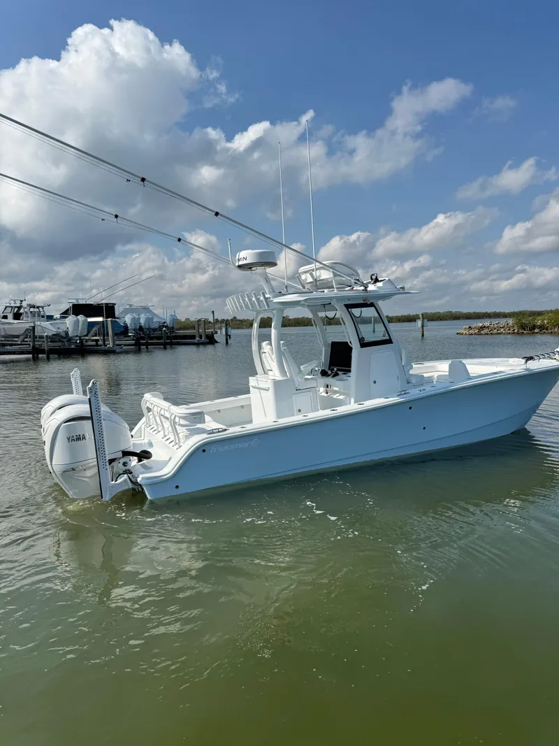 Slide: The Image of 2025 Freeman 28 boat on calm water under a partly cloudy sky. - 3