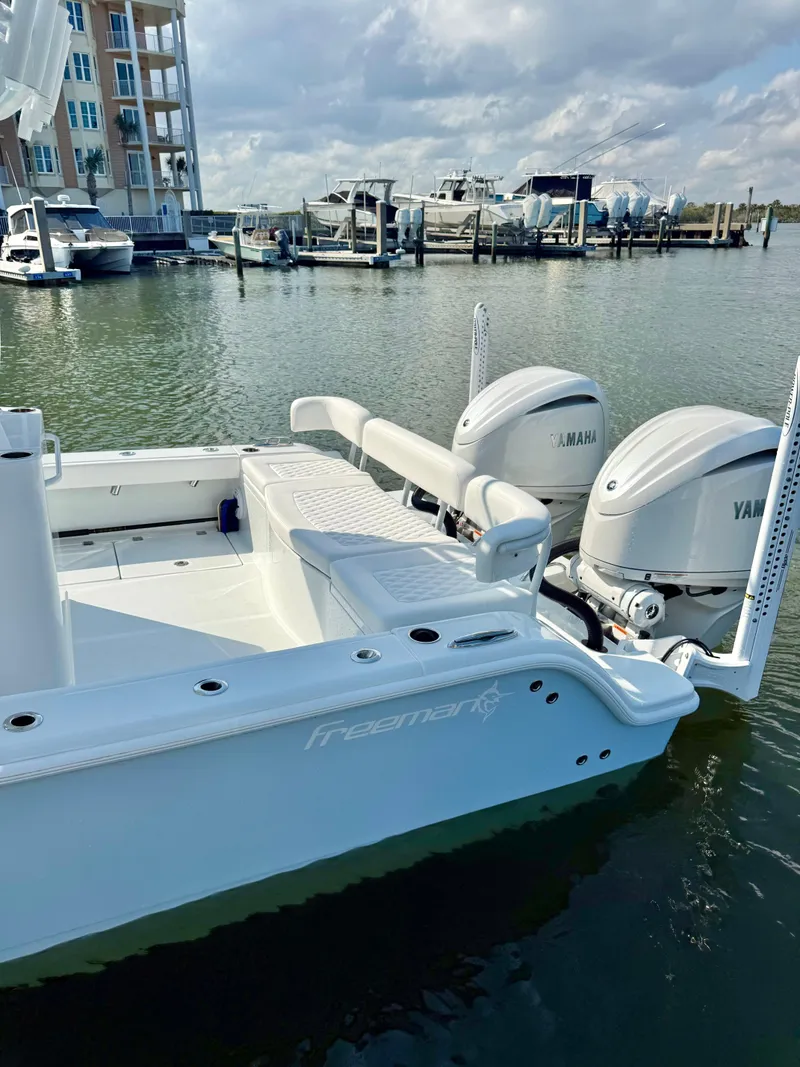 Slide: The Image of Freeman 28 boat with twin Yamaha engines docked at a marina, 2025 model. - 5