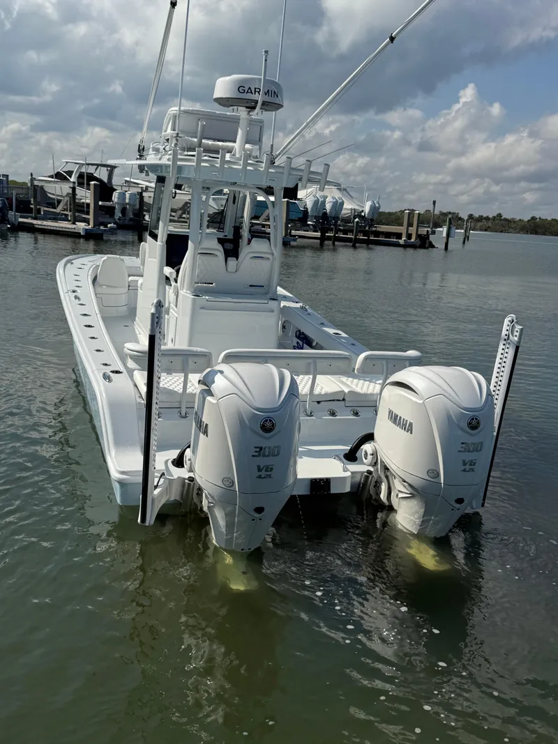 Slide: The Image of 2025 Freeman 28 boat with twin Yamaha 300 engines docked in calm waters. - 6