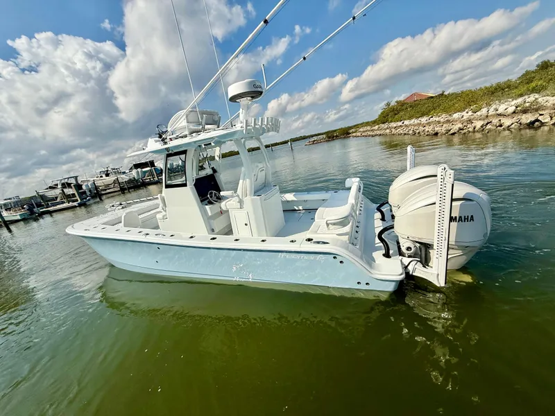 Slide: The Image of 2025 Freeman 28 boat with Yamaha engine on calm water under blue sky. - 8