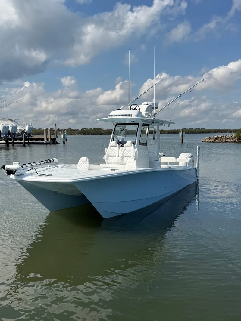 Slide: The Image of 2025 Freeman 28 boat on calm water under a partly cloudy sky. - 9