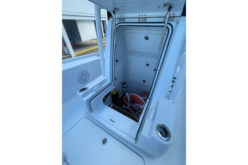 Slide: The Image of 2015 Barker Boatworks 26 Bay with T-top under a blue sky. - 13