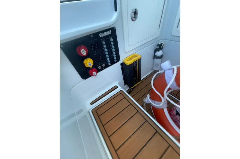 Slide: The Image of 2015 Barker Boatworks 26 Bay interior storage compartment with open hatch and visible equipment. - 14