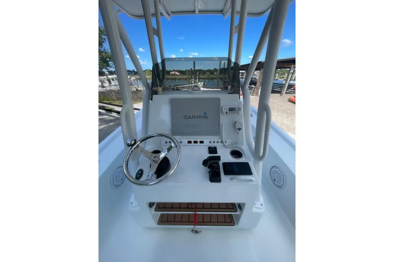 Slide: The Image of 2015 Barker Boatworks 26 Bay interior with control panel, life preserver, and fire extinguisher. - 15