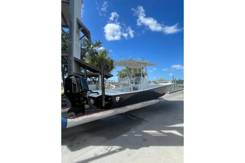 Slide: The Image of 2015 Barker Boatworks 26 Bay on forklift at marina, sunny day. - 2