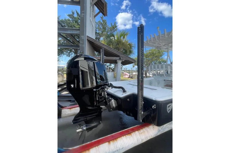 Slide: The Image of 2015 Barker Boatworks 26 Bay outboard motor close-up, showcasing propeller and lower unit. - 31