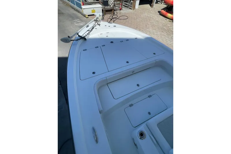 Slide: The Image of 2015 Barker Boatworks 26 Bay on trailer under clear blue sky. - 4