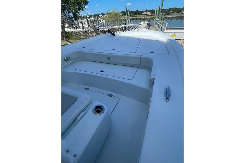 Slide: The Image of 2015 Barker Boatworks 26 Bay deck with trolling motor and storage compartments. - 6