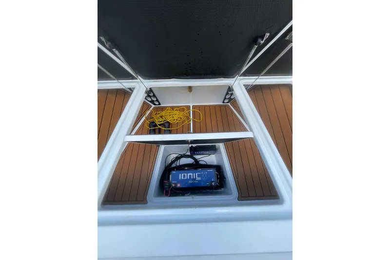 Slide: The Image of 2015 Barker Boatworks 26 Bay with open storage compartments at a dockside location. - 8