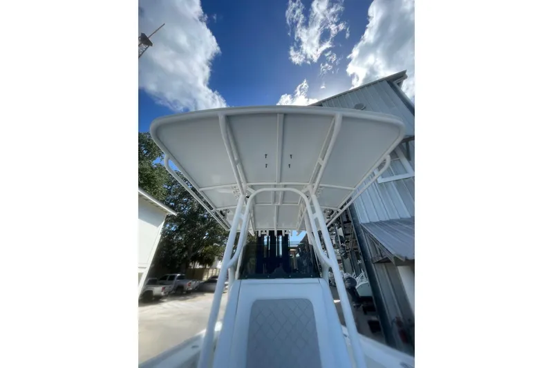 Slide: The Image of 2015 Barker Boatworks 26 Bay, center console view, white interior, docked at marina. - 12