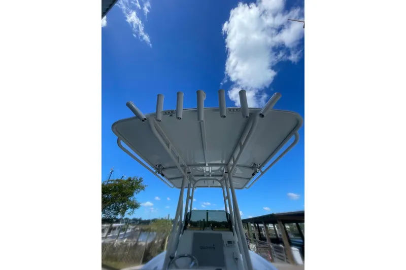 Slide: The Image of 2015 Barker Boatworks 26 Bay console with Garmin navigation, steering wheel, and controls. - 16