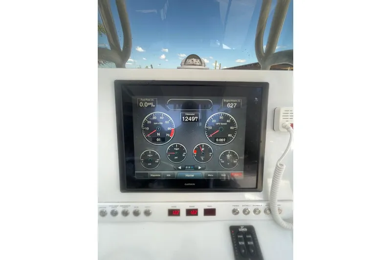 Slide: The Image of 2015 Barker Boatworks 26 Bay with T-top against a clear blue sky. - 17