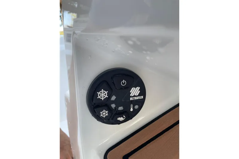 Slide: The Image of Control panel of a 2015 Barker Boatworks 26 Bay with navigation and communication equipment. - 22