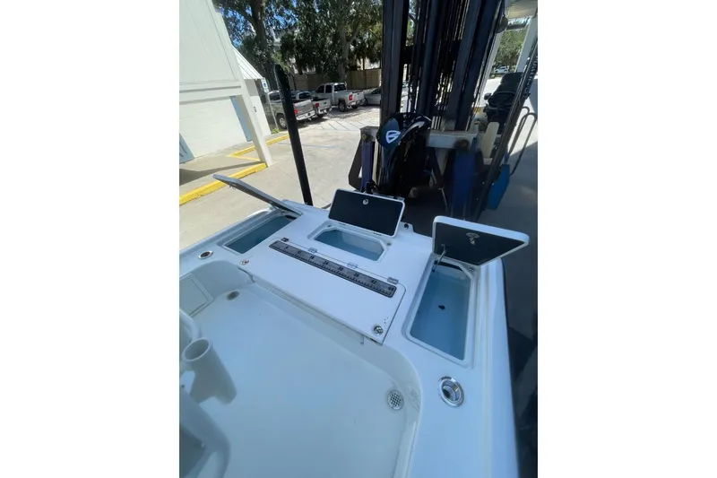 Slide: The Image of 2015 Barker Boatworks 26 Bay interior with cushioned seating and cup holders. - 26