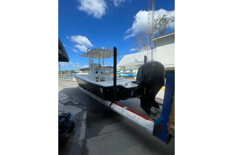 Slide: The Image of 2015 Barker Boatworks 26 Bay on trailer under clear blue sky. - 3