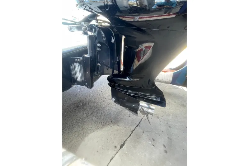 Slide: The Image of 2015 Barker Boatworks 26 Bay with powerful outboard motor in a sunny marina. - 30