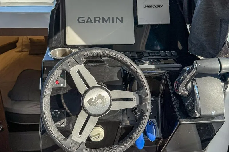Slide: The Image of 2024 Beneteau Antares 9 helm with Garmin and Mercury controls. - 4