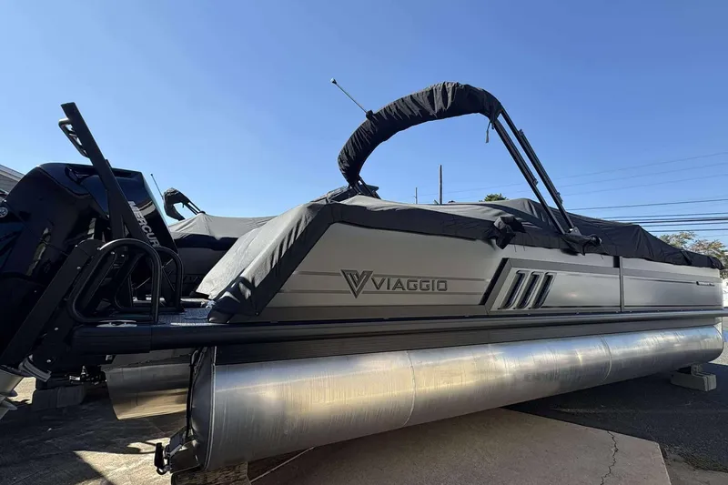 The Image of 2026 Viaggio D26U pontoon boat with cover, featuring sleek design and Mercury engine. - 1