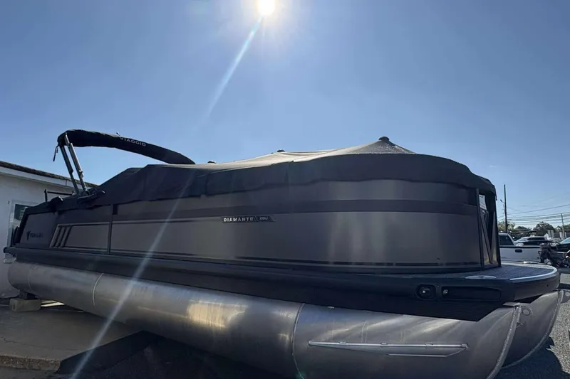 Slide: The Image of 2026 Viaggio D26U pontoon boat under a clear blue sky. - 2